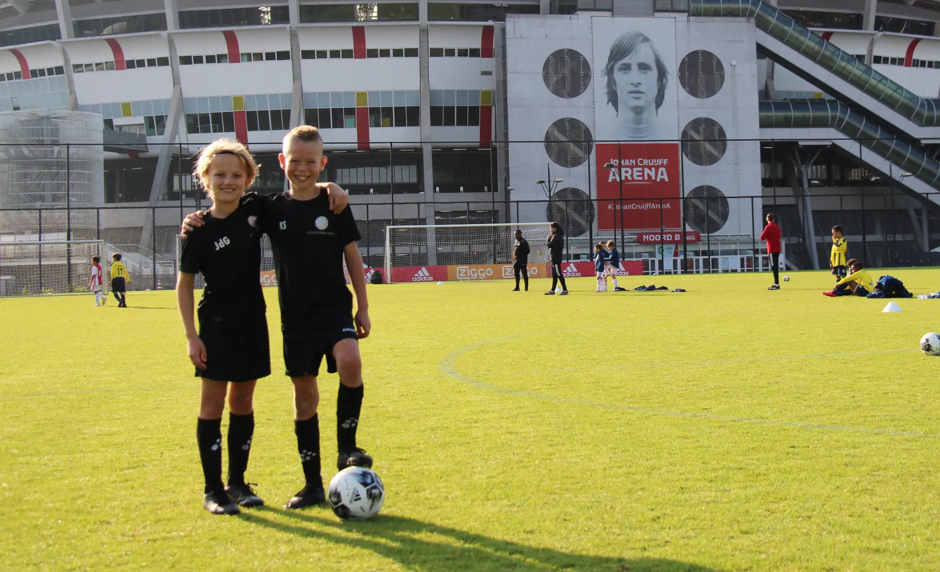 Jonge voetballers van IM Sports op het veld bij de Johan Cruijff ArenA